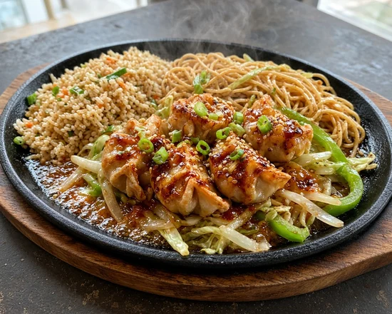 Momo Sizzler on a cast-iron sizzler plate with onion and green pepper